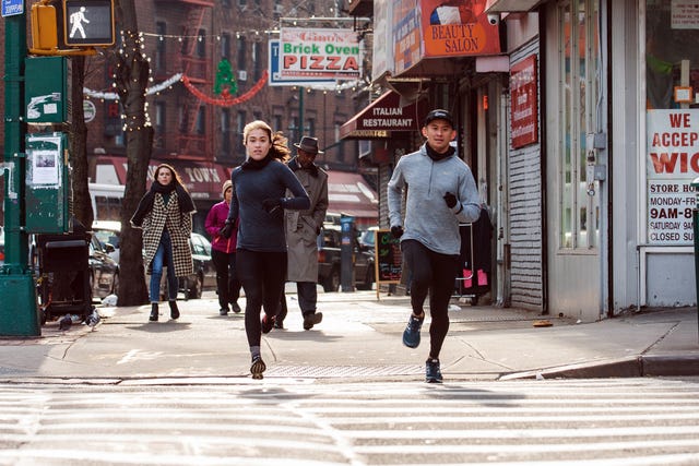 two runners at a crosswalk