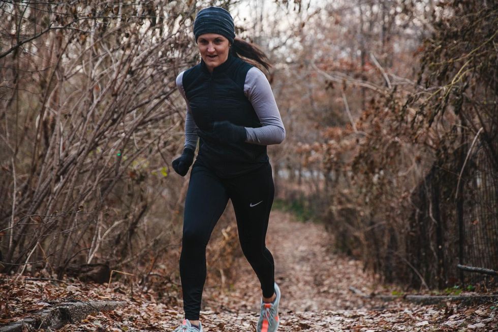 woman running in woods in cold weather