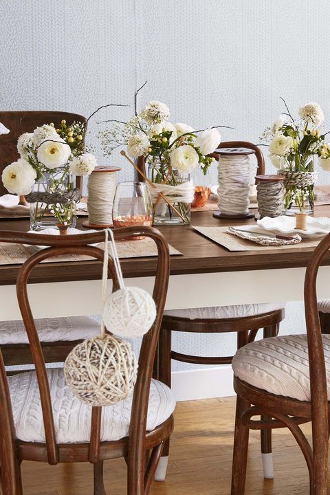 table setting with yarn spools as centerpieces