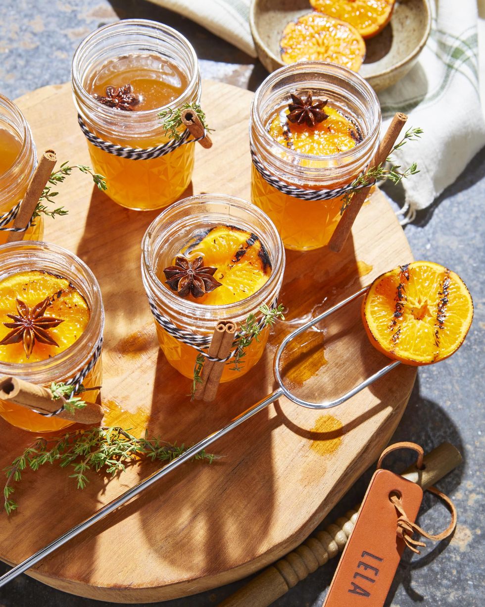 hot toddy in mason jars with charred oranges and star anise