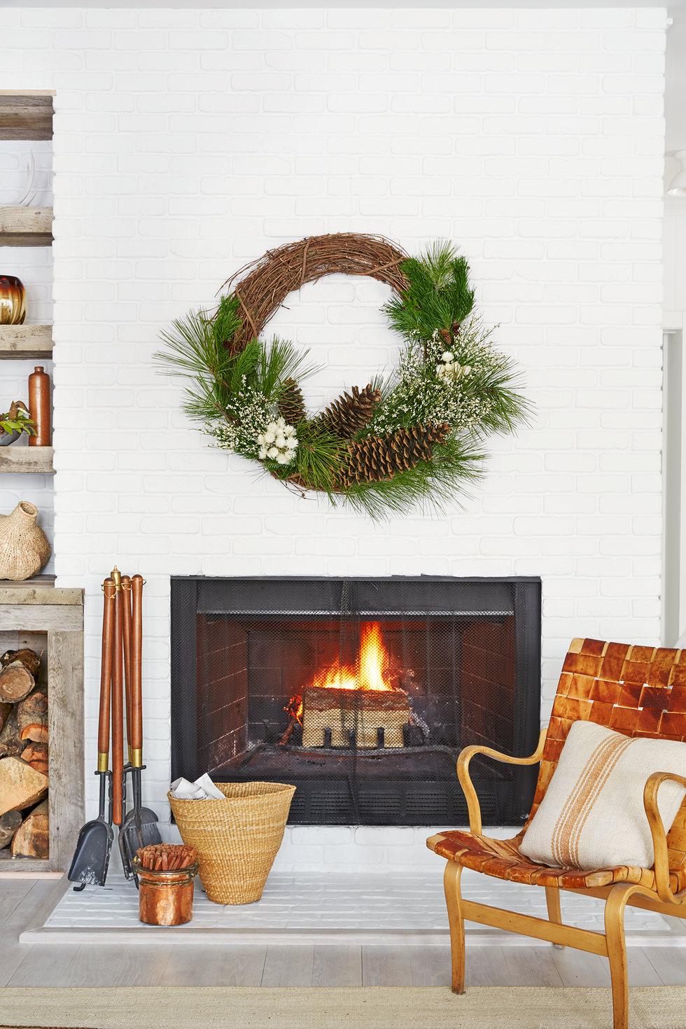 white fireplace hearth with a rustic wreath
