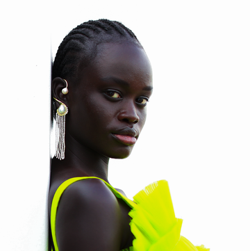 a model wears a pearl ear cuff with dramatic fringe