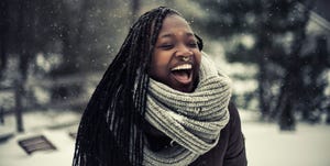 winter quotes young woman laughing while it's snowing outside