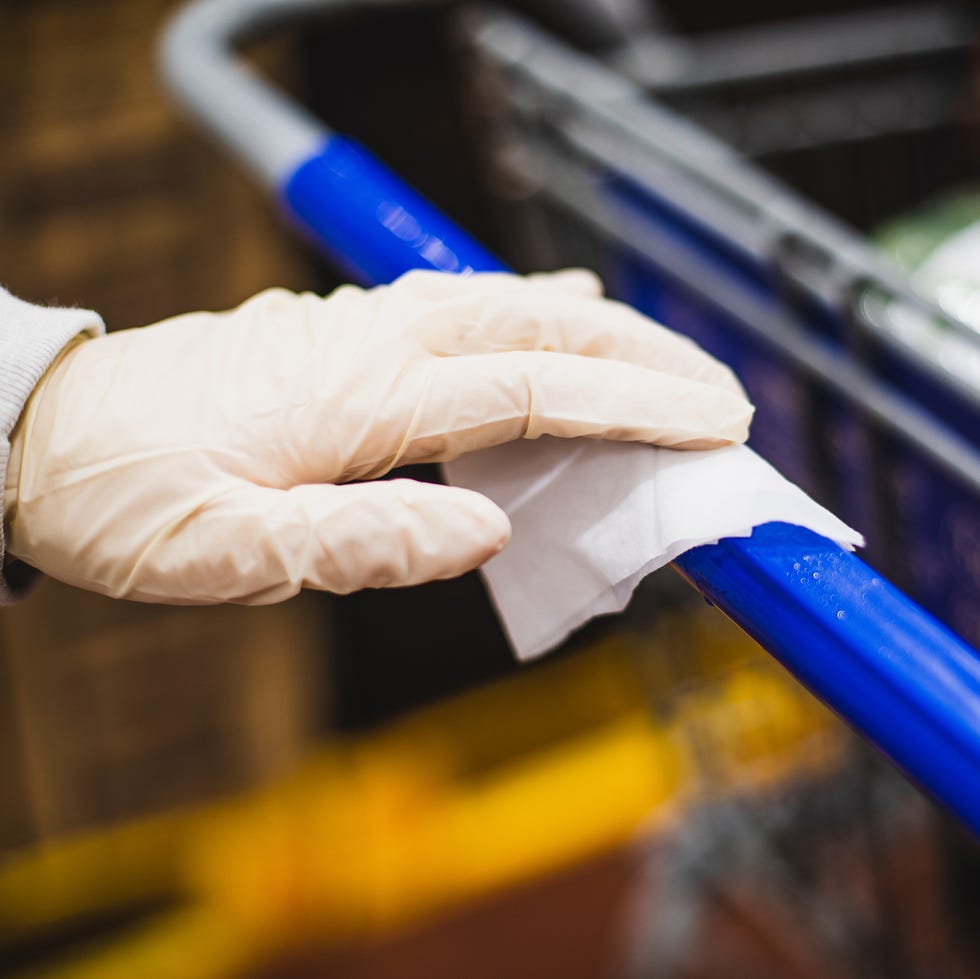 wiping down shopping cart surface wiping down shopping cart surface