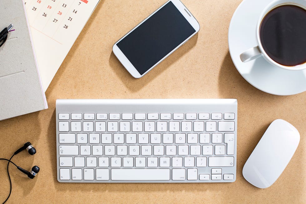 Wireless keyboard, mouse and cell phone on table