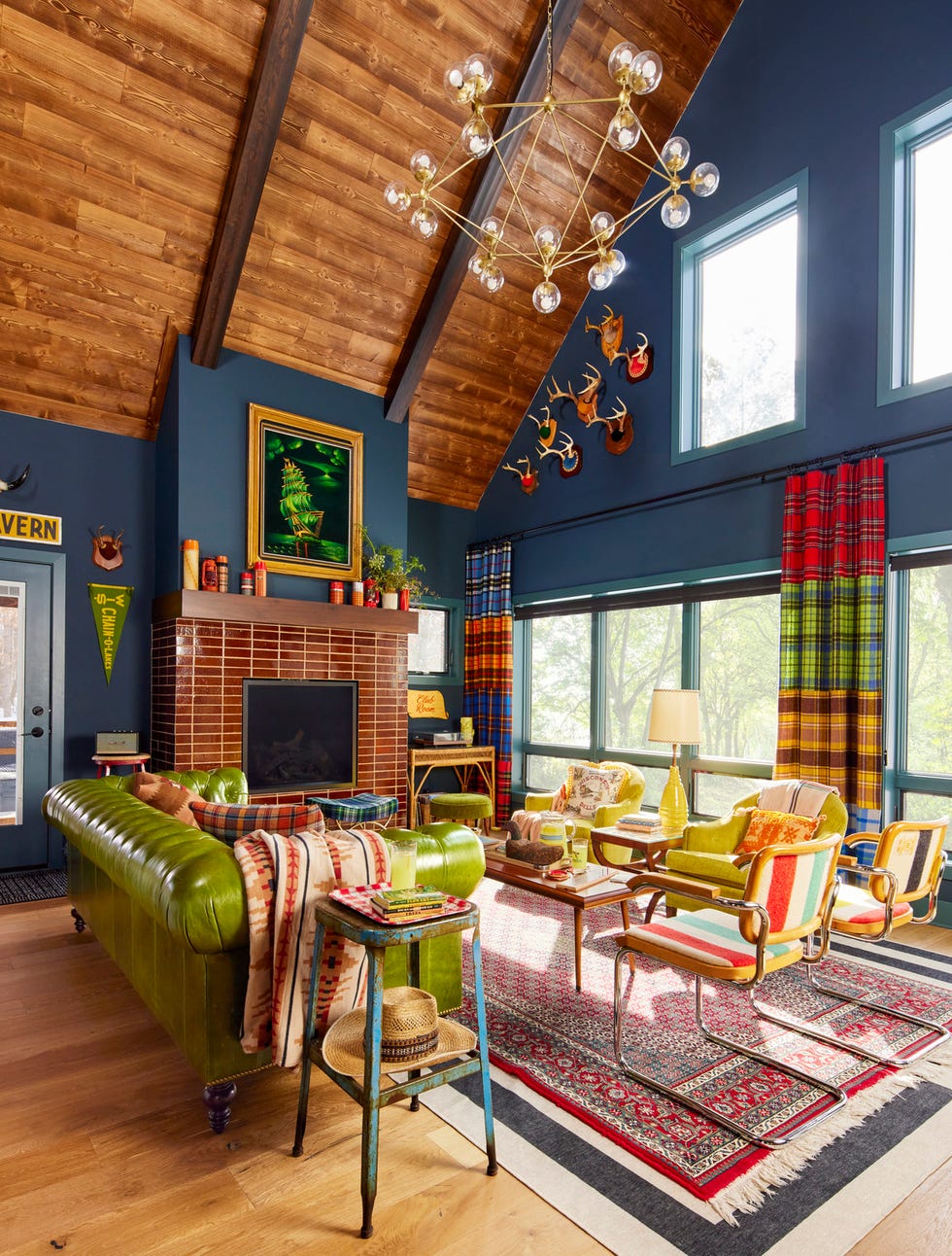 a living room with navy blue walls and green and red and yellow furniture and accessories