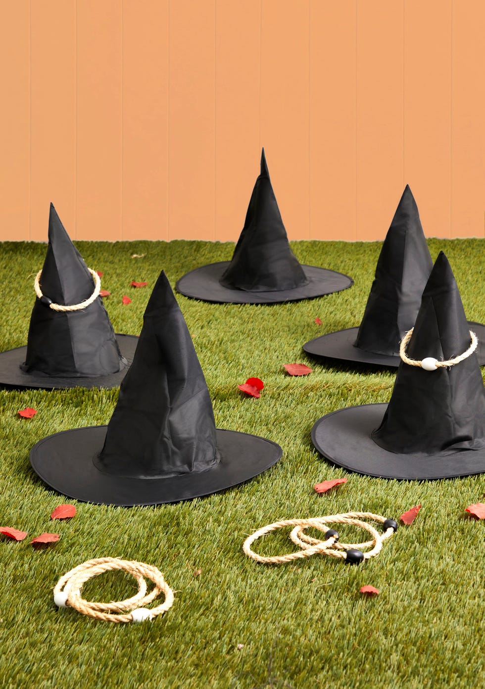 witch hats scattered on grass with ring toss circles for playing