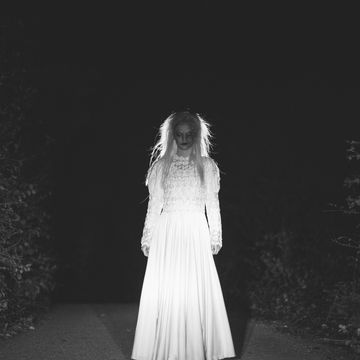 una mujer fantasmal en una carretera