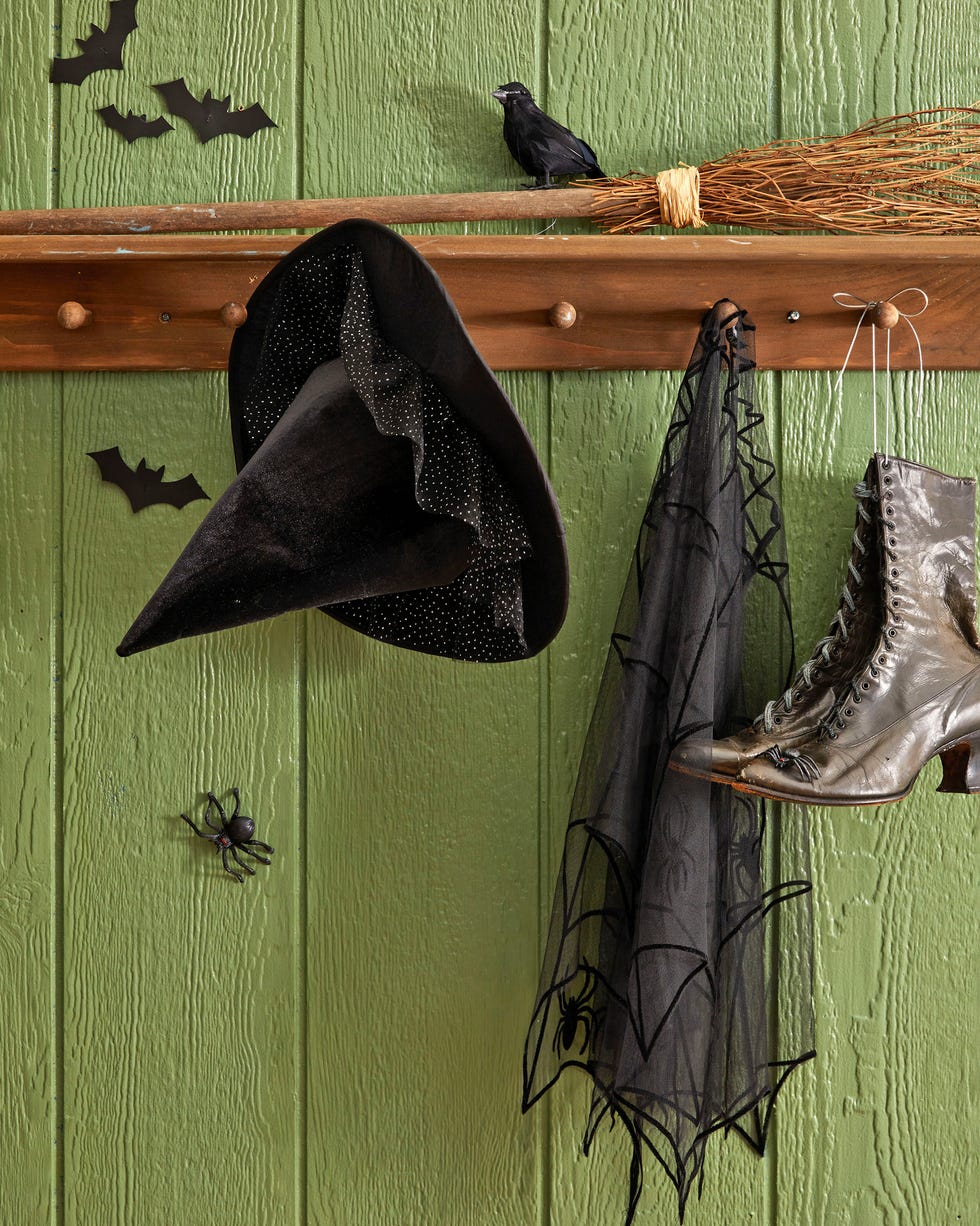 a witch hat cape boots and broom set up on a shelf inside the front door to act as a witches station a witch hat cape boots and broom set up on a shelf inside the front door to act as a witches station