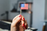 with american flag in her hand independence day