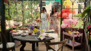 outdoor gathering table adorned with food and flowers