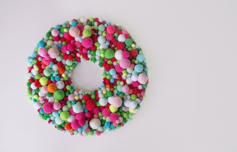 christmas wreath with multi colored pom poms