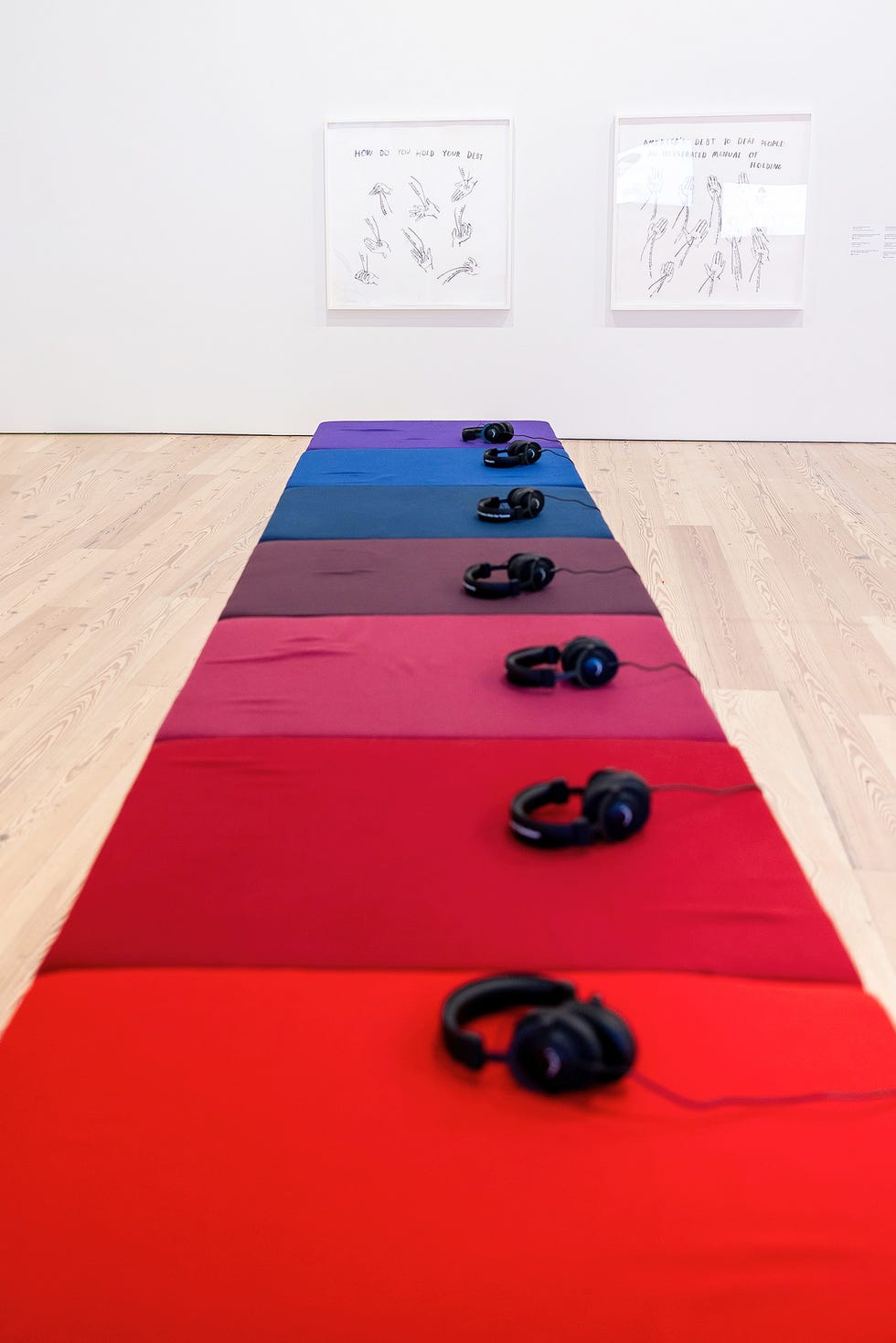 Interactive art installation featuring headphones and colored fabric pads