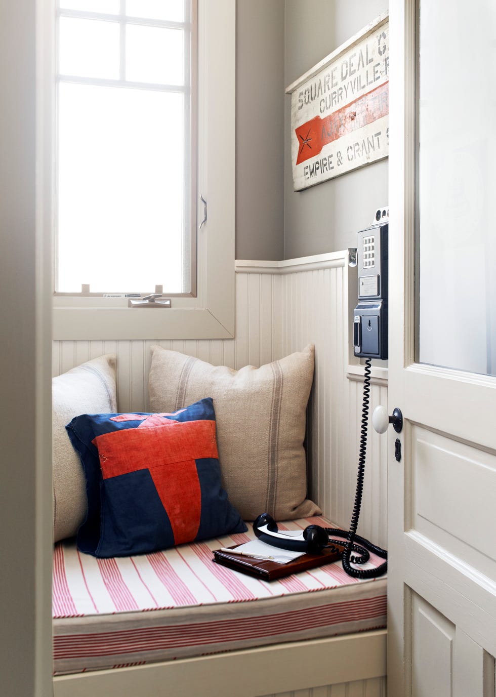 bench in closet with wall phone