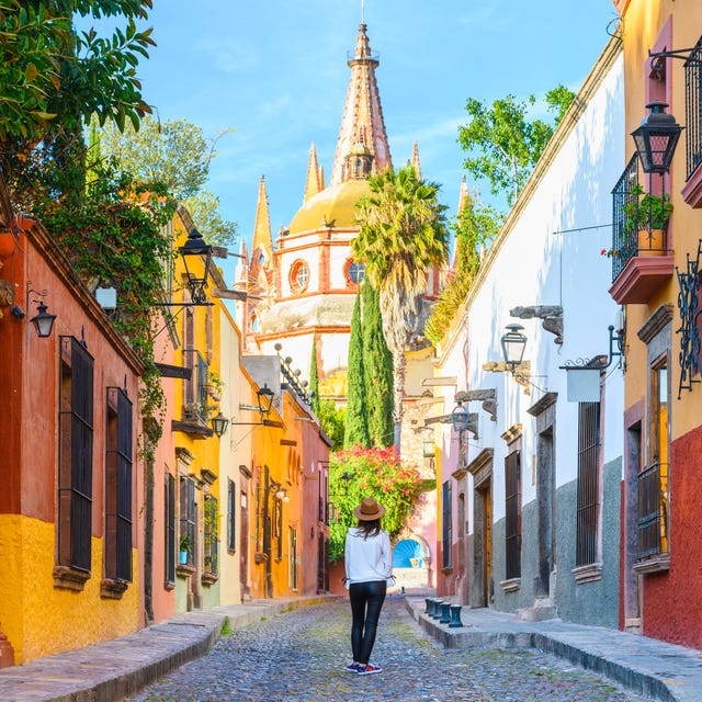 woman admiring the parish church in san miguel de allende, mexico