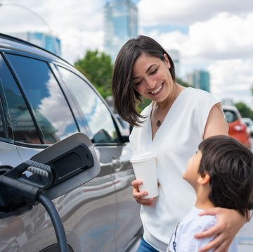 woman and child charging electric car