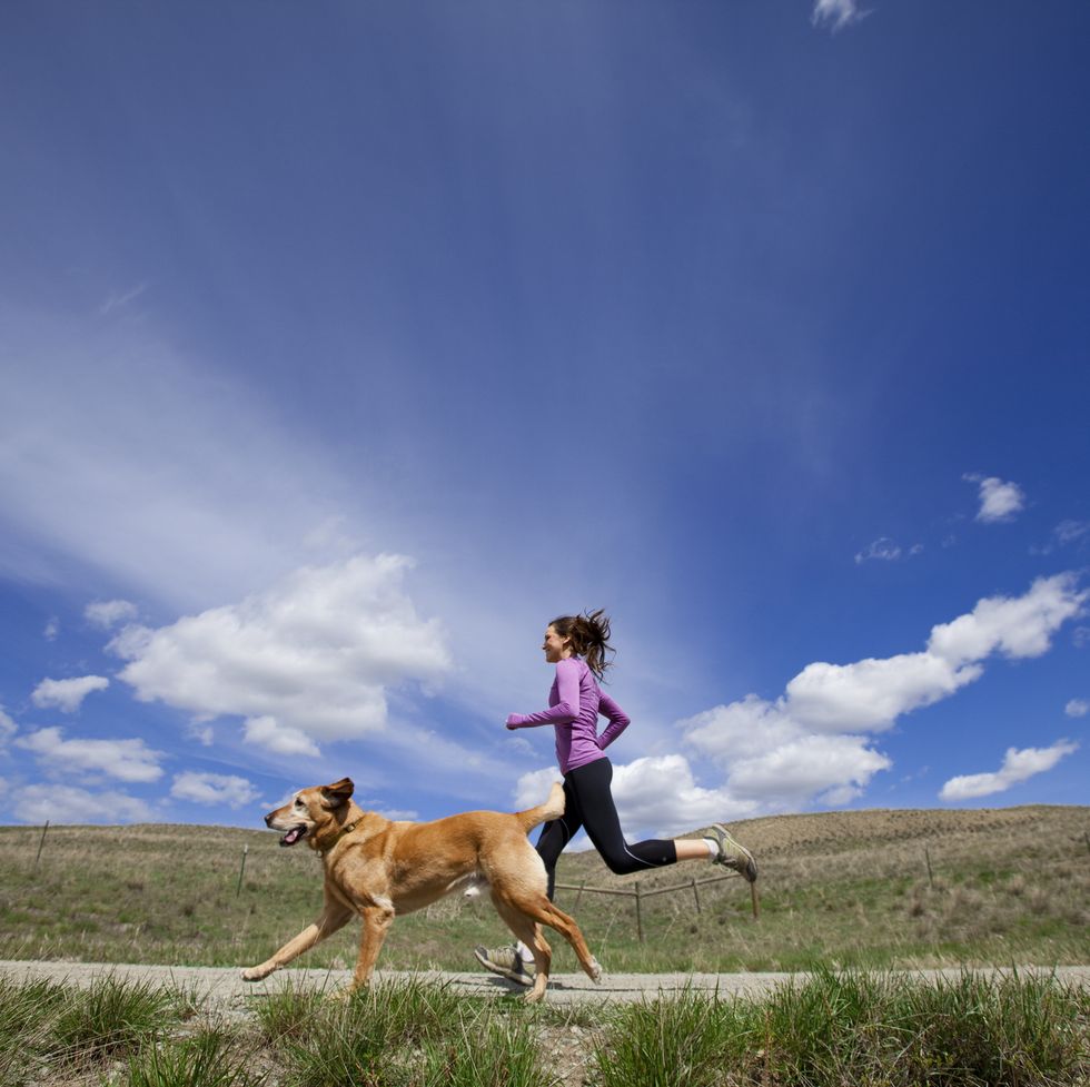 a woman and her dog jogging