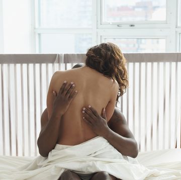 woman and man hugging in bed