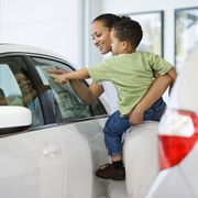 woman and son looking at car's sticker price
