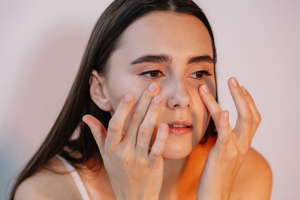 woman applying eye cream