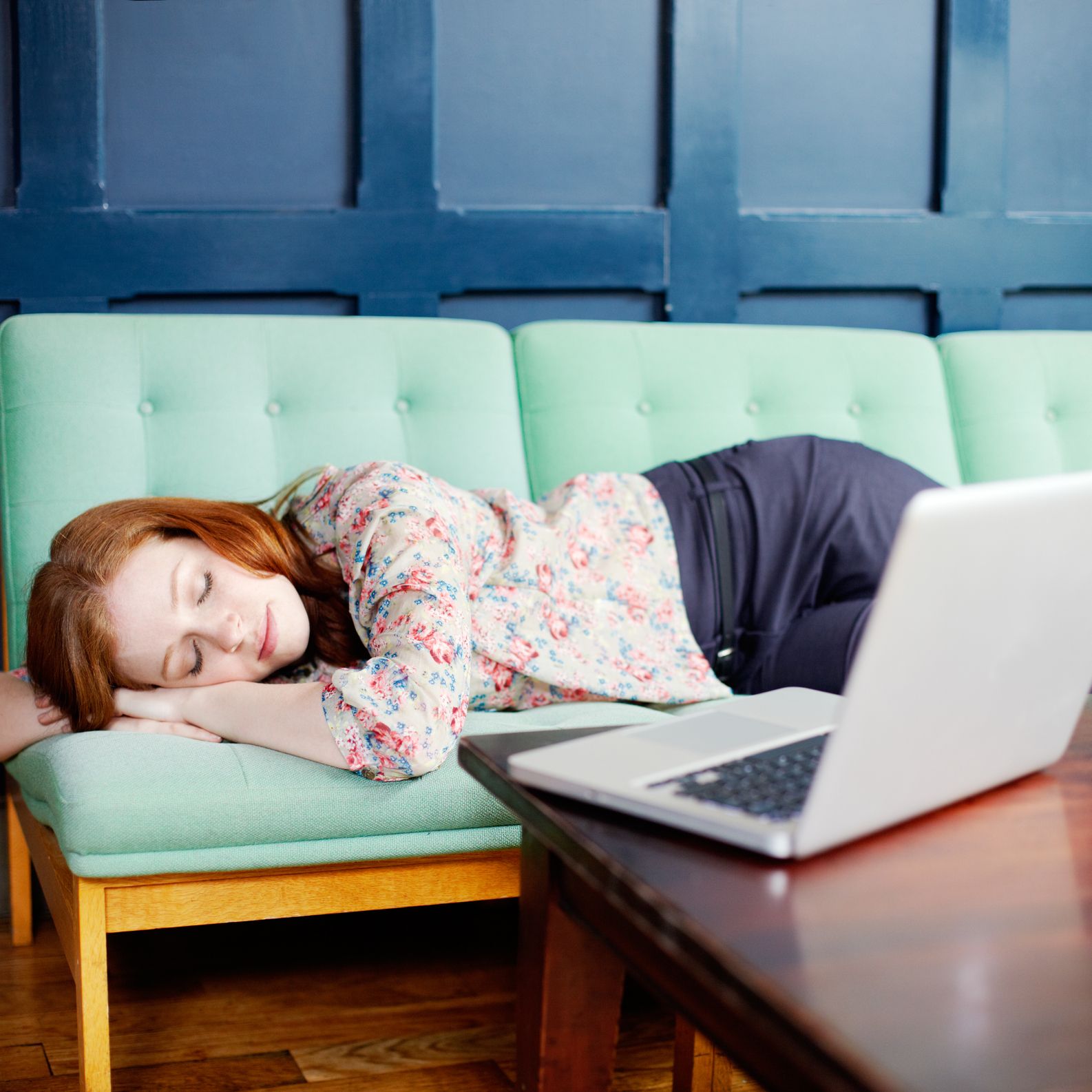 woman asleep on sofa with laptop