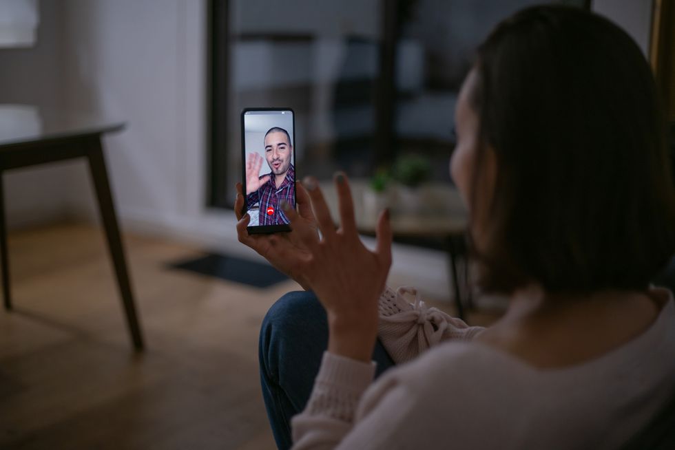 woman at home talking to her boyfriend on a video call