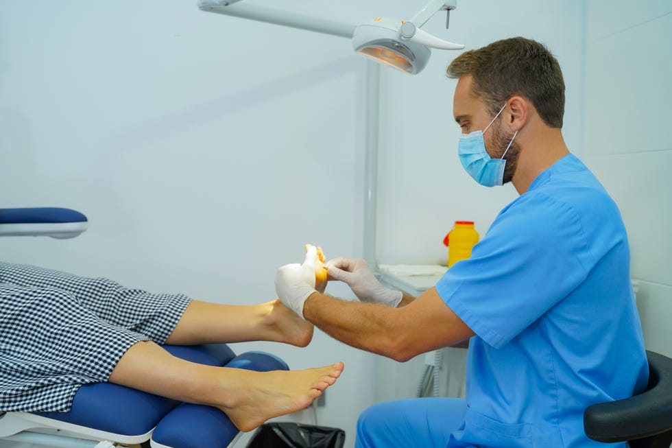 woman attends podiatry specialist for pain in her feet