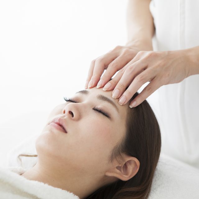 woman being massaged by a salon with her forehead