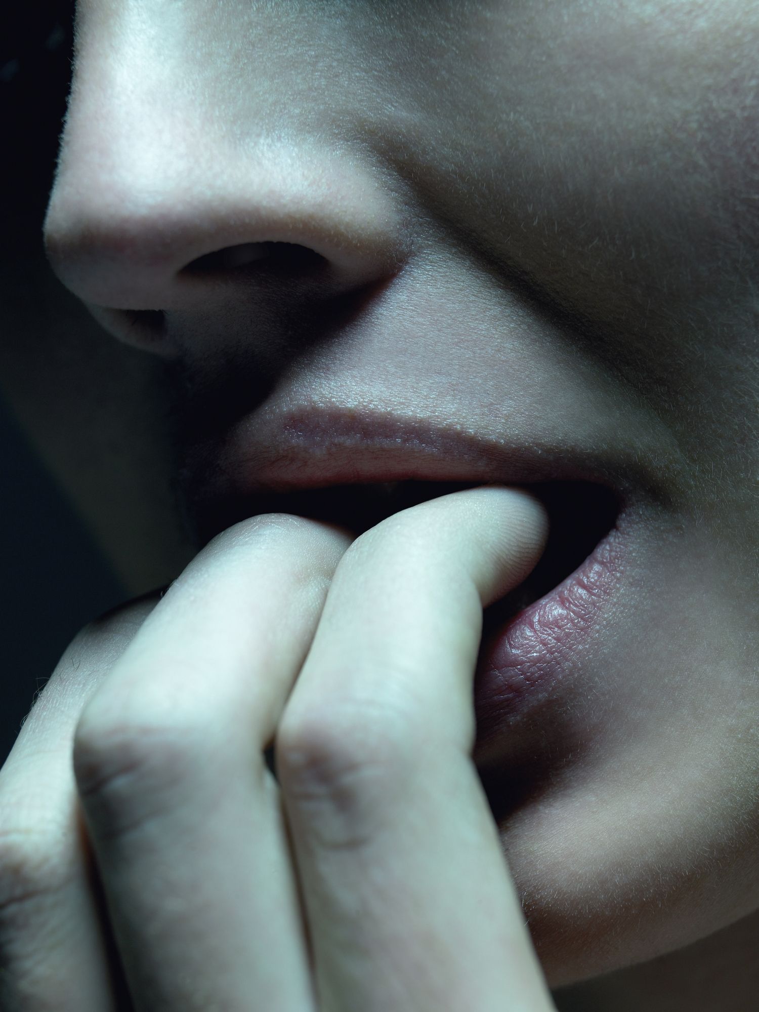 woman biting her fingers