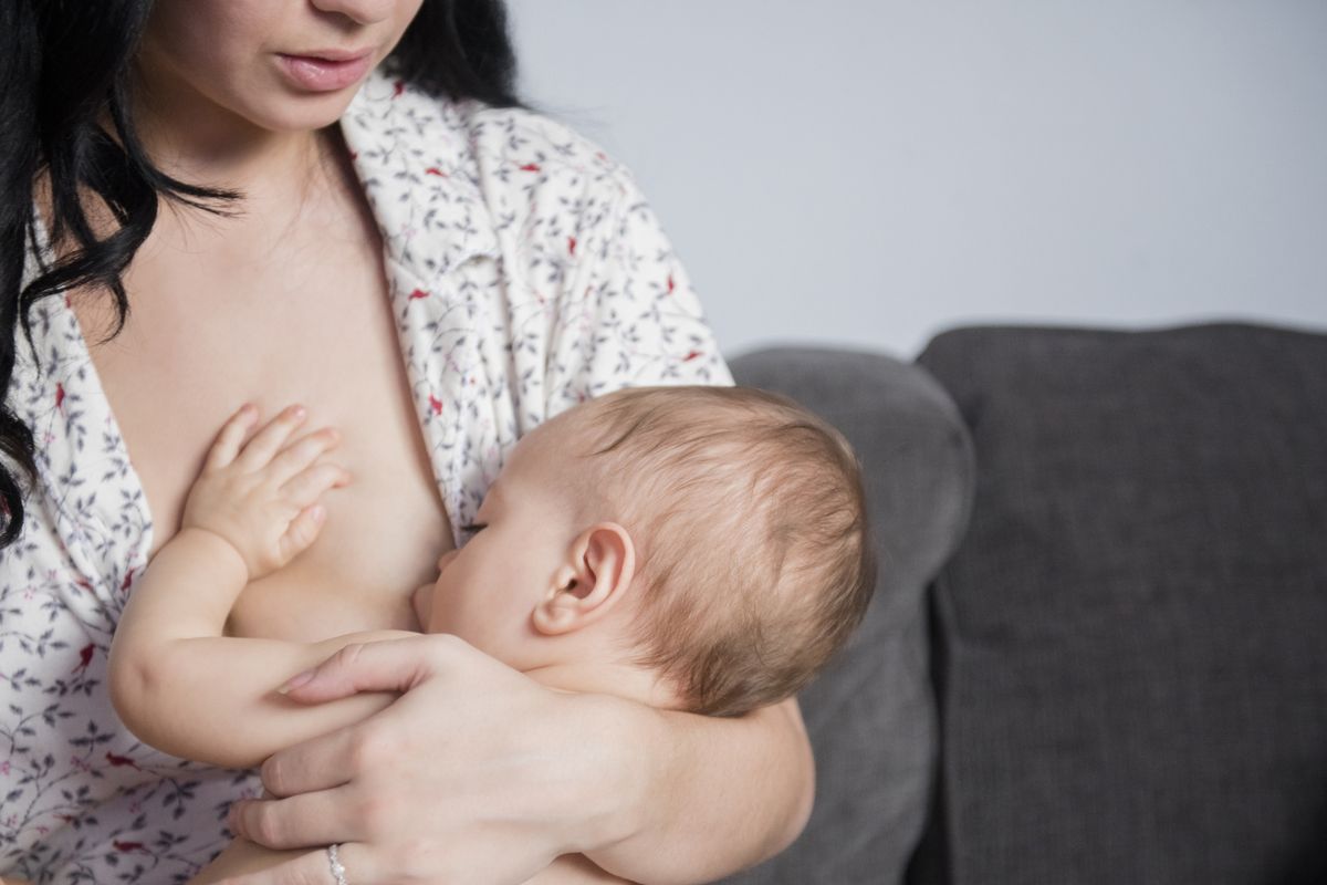 woman breastfeeds baby 