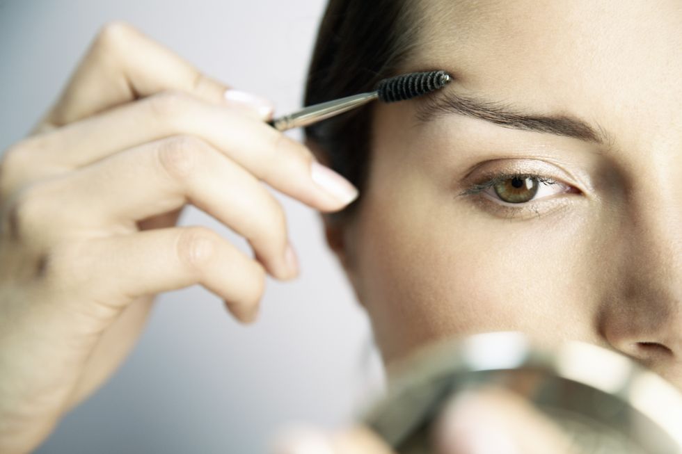Woman Brushing Eyebrows