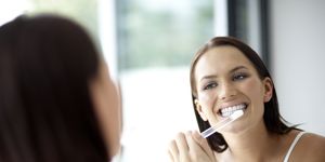 Woman brushing her teeth, close-up