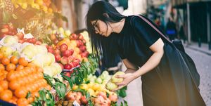 Woman Buying Fruits on Street Market