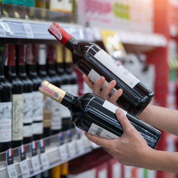 woman buying wine in the supermarket