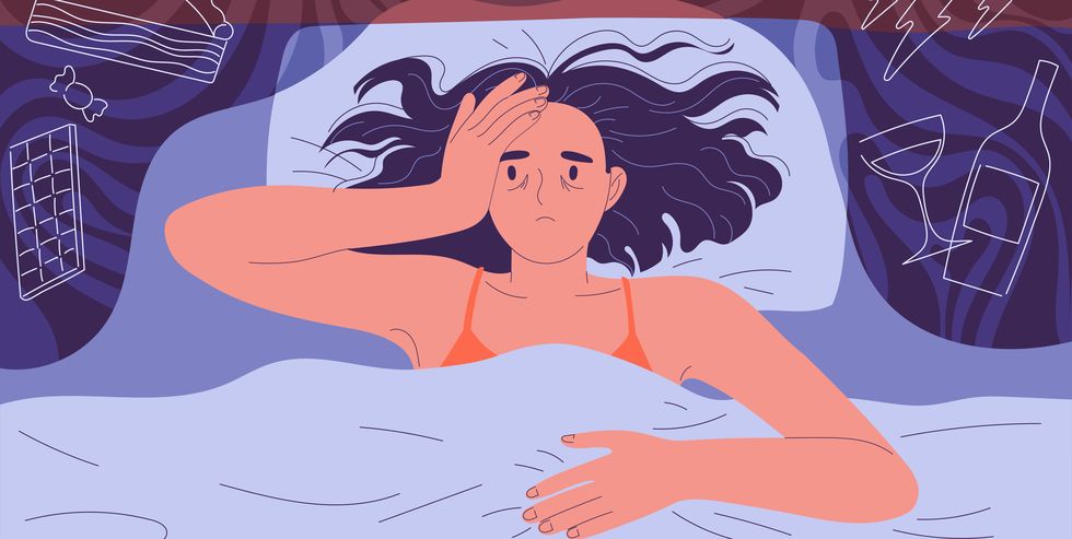 woman cannot fall asleep at night lying on the bed