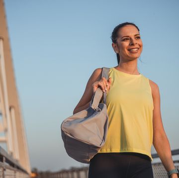 woman carrying gym bag while going for morning workout