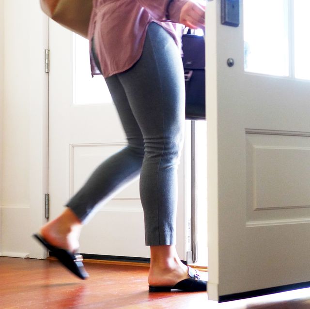 Woman carrying walking out from door.