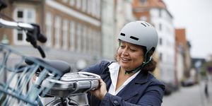 woman changing battery on electric bicycle