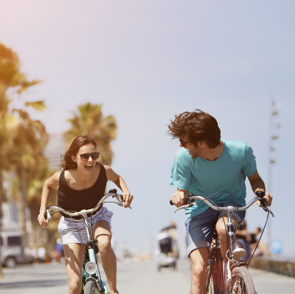 woman chasing man while riding bicycle