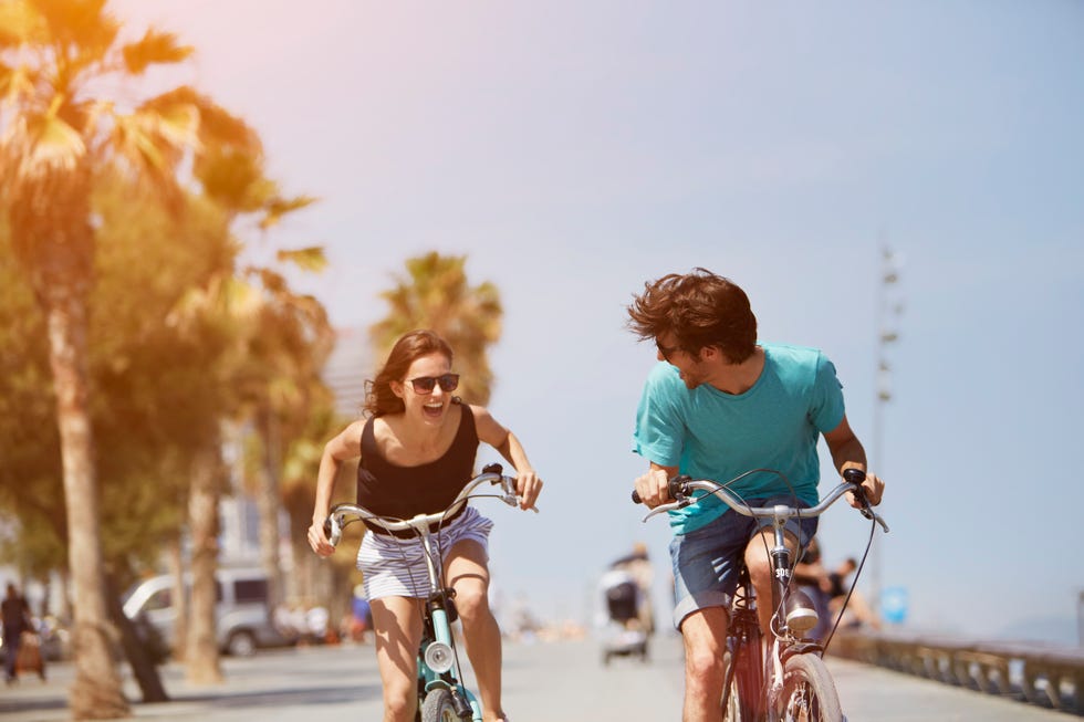 woman chasing man while riding bicycle