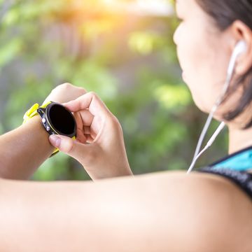 woman checking fitness and health tracking running activity
