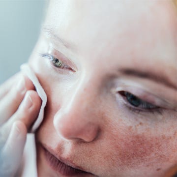 woman cleaning her face