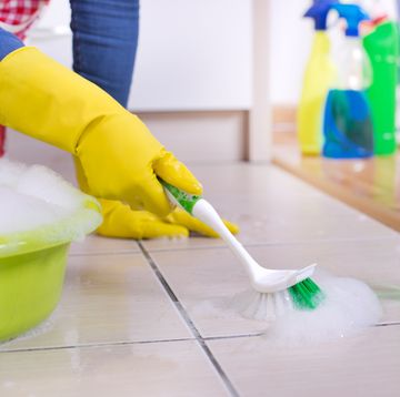 woman cleaning kitchen floor