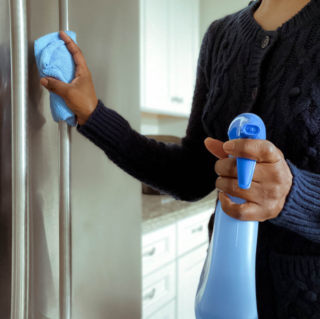 woman cleans refrigerator