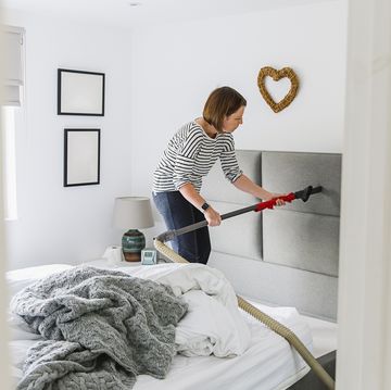 woman deep cleaning her bedroom