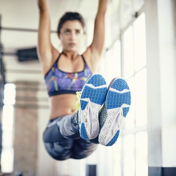 vrouw doet hanging knee raise oefening