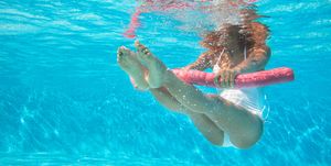 woman doing water aerobics in a pool