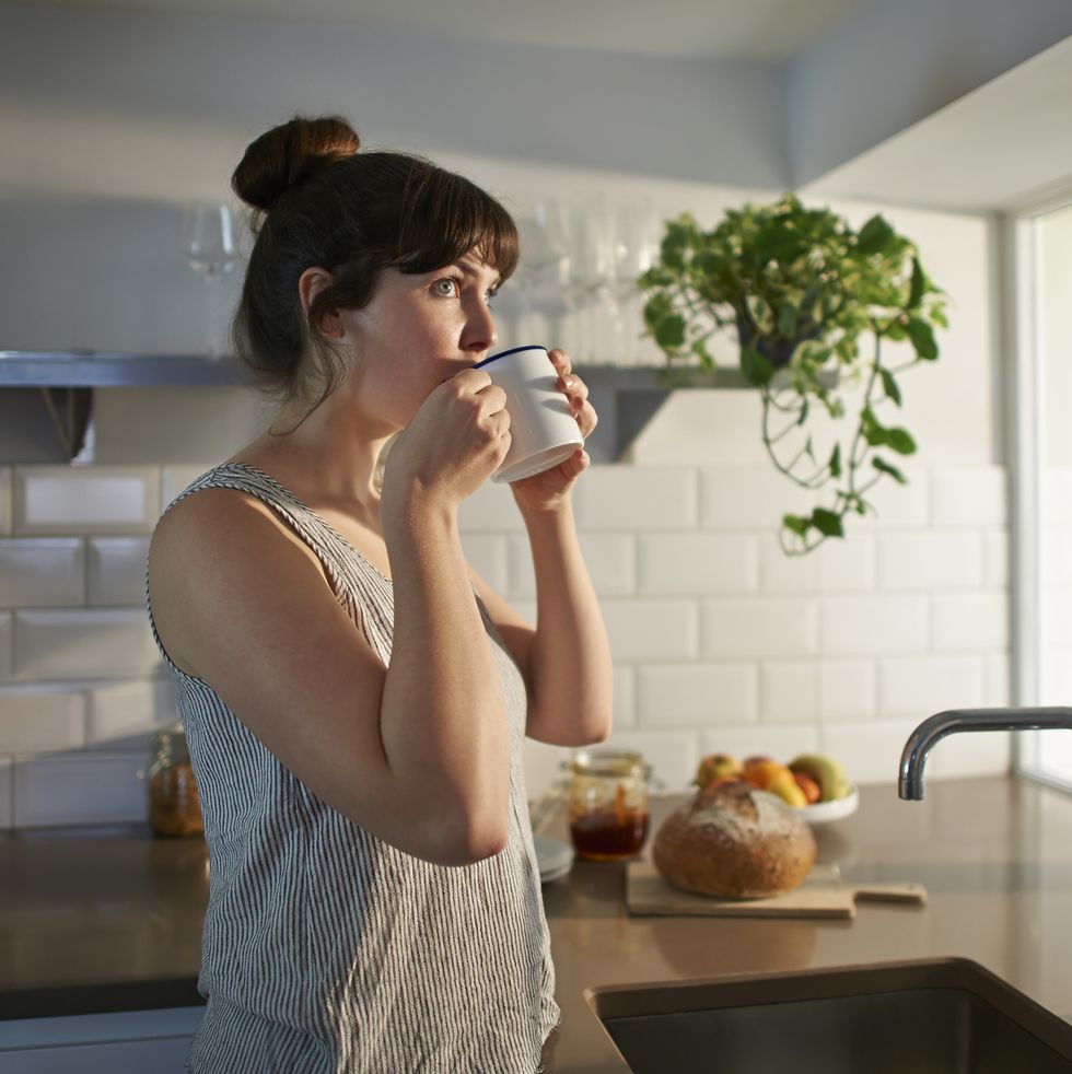 woman drinking from mug in zero waste kitchen