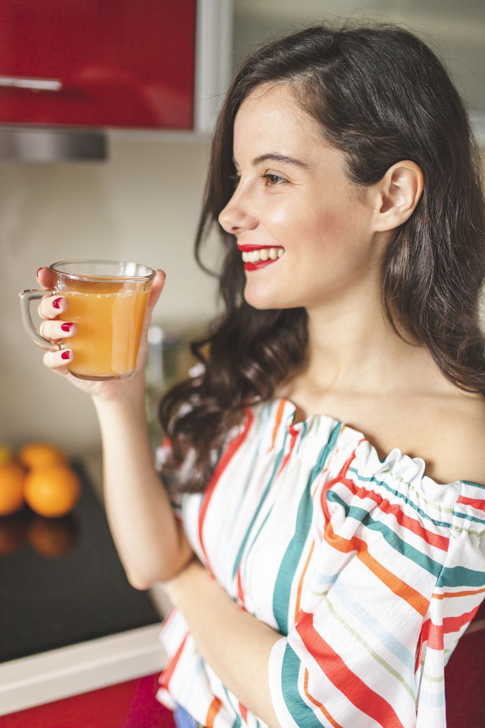 woman drinking orange and carrot juice