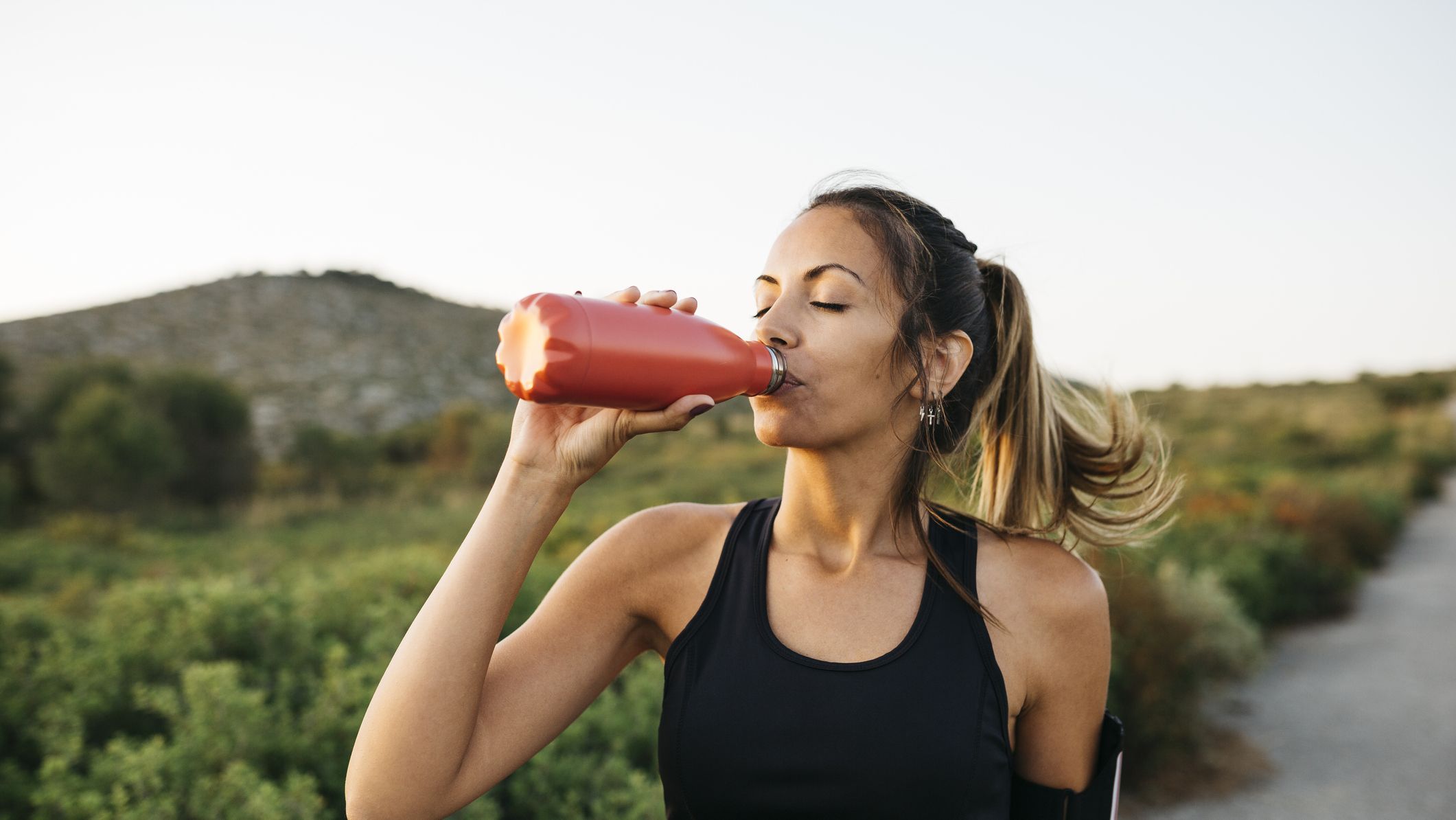 https://hips.hearstapps.com/hmg-prod/images/woman-drinking-water-after-workout-royalty-free-image-1697127089.jpg?crop=1xw:0.84415xh;center,top